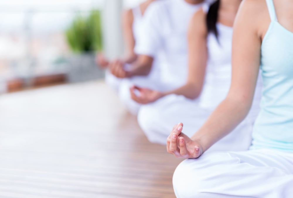 Group of people relaxing and doing yoga