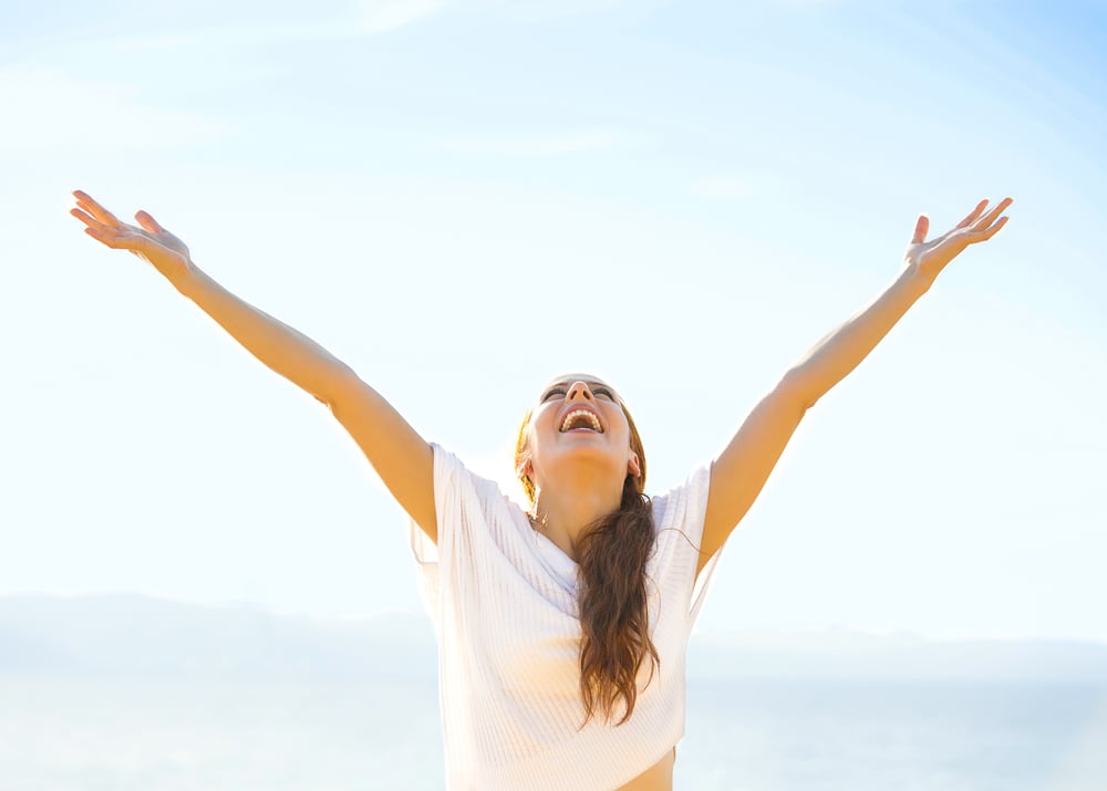 Woman smiling arms raised up to blue sky, celebrating freedom. Positive human emotions, face expression feeling life perception success, peace of mind concept. Free Happy girl on beach enjoying nature Woman smiling arms raised up to blue sky, celebrating freedom. Positive human emotions, face expression feeling life perception success, peace of mind concept. Free Happy girl on beach enjoying nature